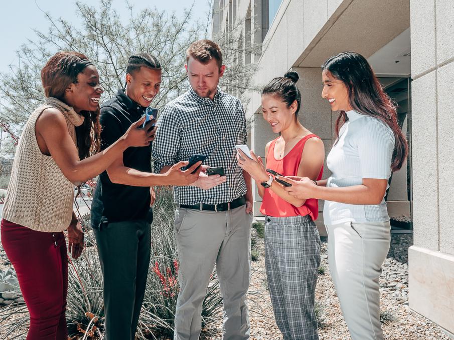 group looking at phones