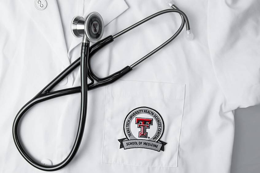 TTUHSC SOM logo, stethoscope, and coat