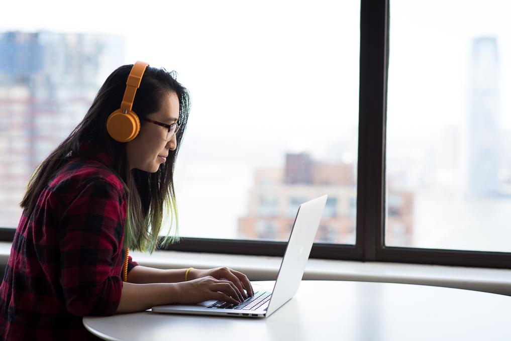 woman wearing headphones on laptop